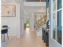 Inviting foyer boasts wood floors, paneled walls, and an open staircase at 424 Hatcher Ct, Hampton, GA 30228