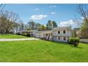 Single Gathering home with a large front yard, 2 car garage and covered entry porch at 1532 Wethersfield Rd, Snellville, GA 30078