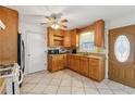 Functional kitchen with wood cabinetry, tile floor, and a ceiling fan at 1532 Wethersfield Rd, Snellville, GA 30078