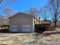 Two-car garage with deck and stairs leading to back yard at 5685 Mccoy Nw Rd, Acworth, GA 30101