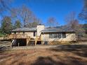 Back of the house with elevated deck and lots of yard space at 5685 Mccoy Nw Rd, Acworth, GA 30101