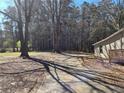 Expansive tree-lined yard and long driveway leading up to the charming home at 5685 Mccoy Nw Rd, Acworth, GA 30101