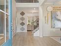 Welcoming home entryway featuring light wood floors and elegant decor at 141 Compass Rd, Hampton, GA 30228