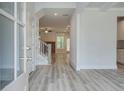 Bright entryway featuring hardwood floors, white trim, staircase, and natural light at 141 Compass Rd, Hampton, GA 30228
