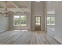 Bright living area featuring high ceilings, plenty of natural light, and plank flooring at 141 Compass Rd, Hampton, GA 30228