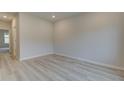 Neutral bedroom showcasing light wood floors, ample natural light, and crisp white trim at 145 Compass Rd, Hampton, GA 30228