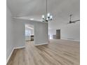 Bright living room featuring a chandelier, ceiling fan, light walls and modern flooring at 1083 Stoney Creek Ln, Austell, GA 30168