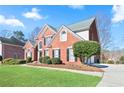 Beautiful two-story red brick home featuring black shutters and an attractive landscaped yard at 325 Stonecastle Pass, South Fulton, GA 30331