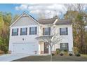 Charming two-story home with a two-car garage and beautifully manicured front yard at 382 Daffodil Dr, Temple, GA 30179