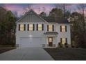 Charming two-story home with a two-car garage and beautifully manicured front yard at 382 Daffodil Dr, Temple, GA 30179