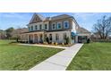 A well-maintained two-story home featuring a spacious lawn, front porch, and additional garage at 400 Hatcher Ct, Hampton, GA 30228