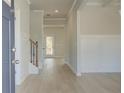 Light and airy foyer showcasing beautiful hardwood floors, modern wainscotting, and an open floor plan at 400 Hatcher Ct, Hampton, GA 30228