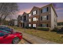 Stylish apartment building featuring stone accents, covered entry, and well-maintained lawn space at 5303 Fairington Club Dr # 5303, Lithonia, GA 30038