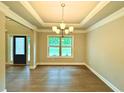 Elegant dining room with hardwood floors, tray ceiling, and chandelier at 123 Honey Creek Rd, Conyers, GA 30094