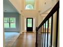 Grand foyer with soaring ceilings and hardwood floors, creating an impressive entry to the home at 123 Honey Creek Rd, Conyers, GA 30094