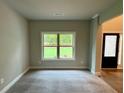 Cozy living room with plush carpeting, ample natural light and a neutral color palette at 123 Honey Creek Rd, Conyers, GA 30094