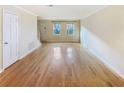 Bright living room featuring gleaming hardwood floors and neutral paint at 165 N River Dr # G, Atlanta, GA 30350