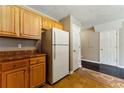 Cozy kitchen with oak cabinets, white appliances, and access to a pantry at 5338 Creekview Ln, Morrow, GA 30260