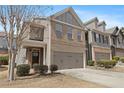 Well-maintained townhome with a two-car garage and cozy curb appeal at 2308 Oakton Se Pl, Smyrna, GA 30082