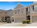 Inviting townhome with neutral colors, a brick facade, and manicured landscaping at 2308 Oakton Se Pl, Smyrna, GA 30082