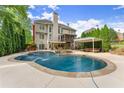 Inviting backyard pool with a waterfall feature and a shaded lounge area at 3070 Corsair Curv, Cumming, GA 30040