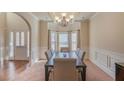 Elegant dining room featuring wainscoting, a chandelier, and a bay window at 7347 Moss Stone Dr, Conyers, GA 30094