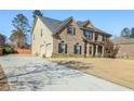 Beautiful home featuring a long driveway, well-maintained lawn, and a brick facade at 7347 Moss Stone Dr, Conyers, GA 30094