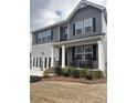 Inviting two-story home boasts rocking-chair front porch, complementary paint colors, and manicured landscaping at 750 Great Oak Pl, Villa Rica, GA 30180