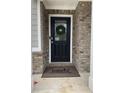 Stylish front door with glass panel, wreath, and 'Liberty Communities' welcome mat at 750 Great Oak Pl, Villa Rica, GA 30180