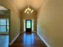 Bright foyer featuring hardwood floors, a modern chandelier, and a view of the front door with sidelights at 125 Honey Creek Rd, Conyers, GA 30094