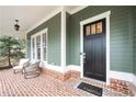 Inviting front porch features classic brickwork and cozy seating, perfect for relaxing at 174 Kelly St, Norcross, GA 30071