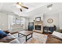 Spacious living room with a stone fireplace, ceiling fan, and large windows at 174 Kelly St, Norcross, GA 30071