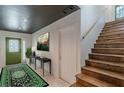 Inviting entryway featuring a green door, staircase, console table, and stylish rug at 3085 Remington St, East Point, GA 30344