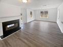 Bright living room with a fireplace, ample natural light, and hardwood-style flooring at 545 Zoie Ln, Palmetto, GA 30268