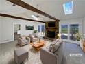 Bright, airy living room with vaulted ceilings, exposed beams, stone fireplace and access to outdoor deck, perfect for entertaining at 1750 Elizabeth Sw Ct, Conyers, GA 30094