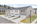 Row of townhomes featuring attached garages and neutral siding, offering a blend of convenience and contemporary design at 464 Reflection Dr # 22, Stockbridge, GA 30281