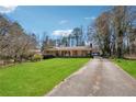 Spacious home with a sprawling green lawn and a long driveway leading to the house at 1198 Seminary Dr, Marietta, GA 30064