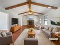 Spacious living room featuring vaulted ceilings, exposed beams, and a cozy stone fireplace at 4508 N Bay Ct, Marietta, GA 30066