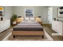 Staged bedroom showcasing a bed, two dressers, and neutral decor at 474 Berckman Nw Dr, Lilburn, GA 30047
