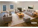 Staged living room featuring hardwood floors, a fireplace, and neutral-toned furniture at 474 Berckman Nw Dr, Lilburn, GA 30047