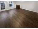 Spacious living room featuring a door to the outside and a fireplace at 474 Berckman Nw Dr, Lilburn, GA 30047