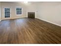 Living room featuring hardwood floors, a fireplace, and ample natural light at 474 Berckman Nw Dr, Lilburn, GA 30047