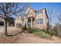Brick house featuring a front yard with trees and landscaping, offering suburban charm at 8955 Shalford Ct, Cumming, GA 30041