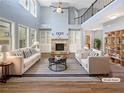 Bright, staged living room with fireplace, built-ins, hardwood floors, and large windows at 4913 Sydney Ln, Marietta, GA 30066