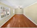 Bright living room with hardwood floors, neutral wall colors and large windows at 7648 Mount Zion Blvd, Jonesboro, GA 30236