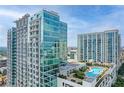 Stunning high-rise apartment building with a rooftop pool and cityscape views on a sunny day at 250 Pharr Ne Rd # 1812, Atlanta, GA 30305