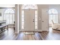 Bright foyer showcasing wood floors, large windows, and neutral color palette at 7145 Hartsfield Pl, Suwanee, GA 30024