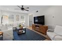 Cozy living room with a modern ceiling fan, updated lighting and refined window shutters at 9 Market Square Nw Pl, Atlanta, GA 30318