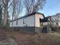 View of the side exterior showcasing the home's siding, windows, and the front porch at 1170 Booker Sw Ave, Atlanta, GA 30310