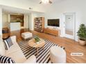 Bright living room with wood floors, modern furniture, and easy access to kitchen at 1250 Parkwood Se Cir # 2309, Atlanta, GA 30339